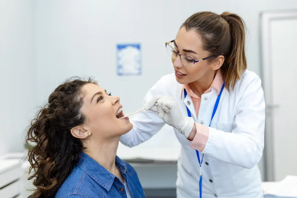 ENT doctor examining a patient’s throat
