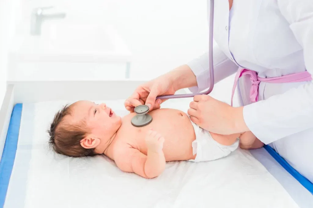 Paediatrician examining a baby with a stethoscope